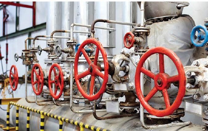 Red handwheel valves on a process line