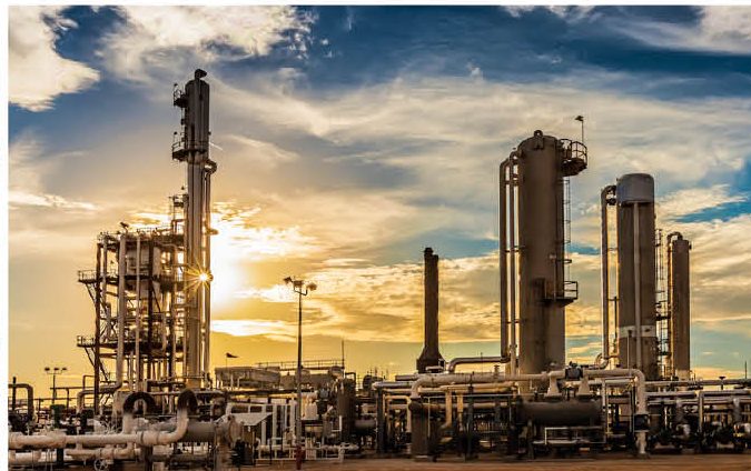 Refinery towers at sunset